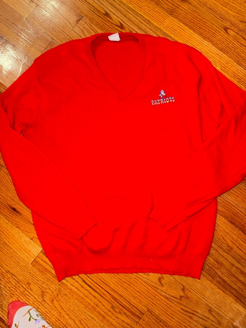 Vintage red New England Patriots V-neck sweater featuring the "Pat Patriot" logo